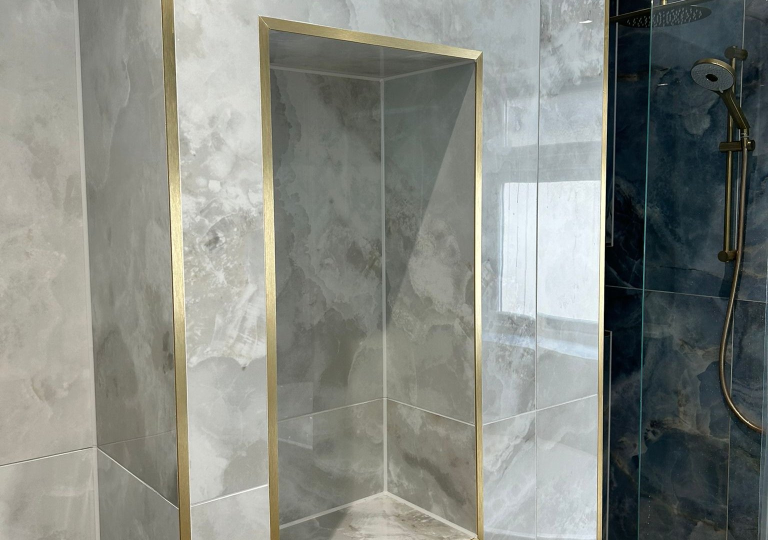 Decorative niche with white onyx Ca' Pietra tiles Brentwood CM13 luxury bathroom