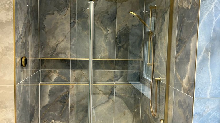 Wetroom shower with blue onyx Ca' Pietra tiles and Elisa Intuition shower kit in brushed brass Brentwood CM13