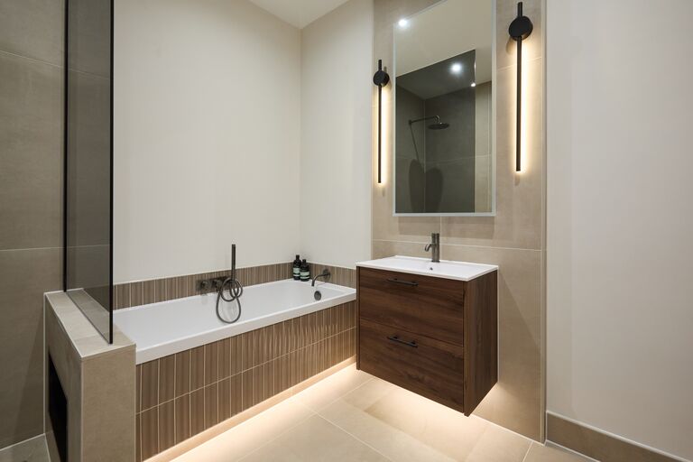 Bath with dark JTP filler and walnut Calypso vanity with mirror Chelmsford CM2 Essex