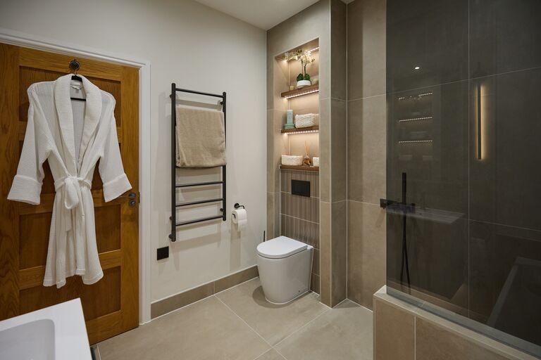 Family bathroom full room with black towel rail back-to-wall WC and walk-in shower Chelmsford CM2 Essex
