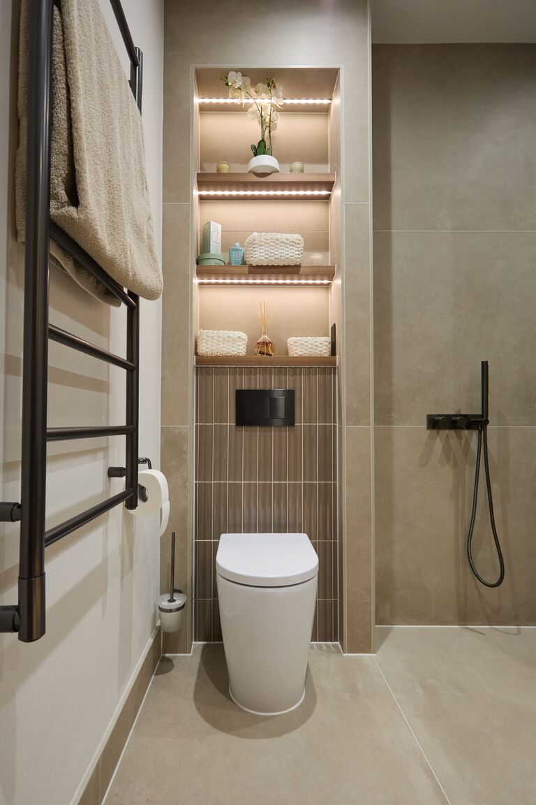 LED-lit niche shelves above back-to-wall WC with black towel rail Chelmsford CM2 Essex