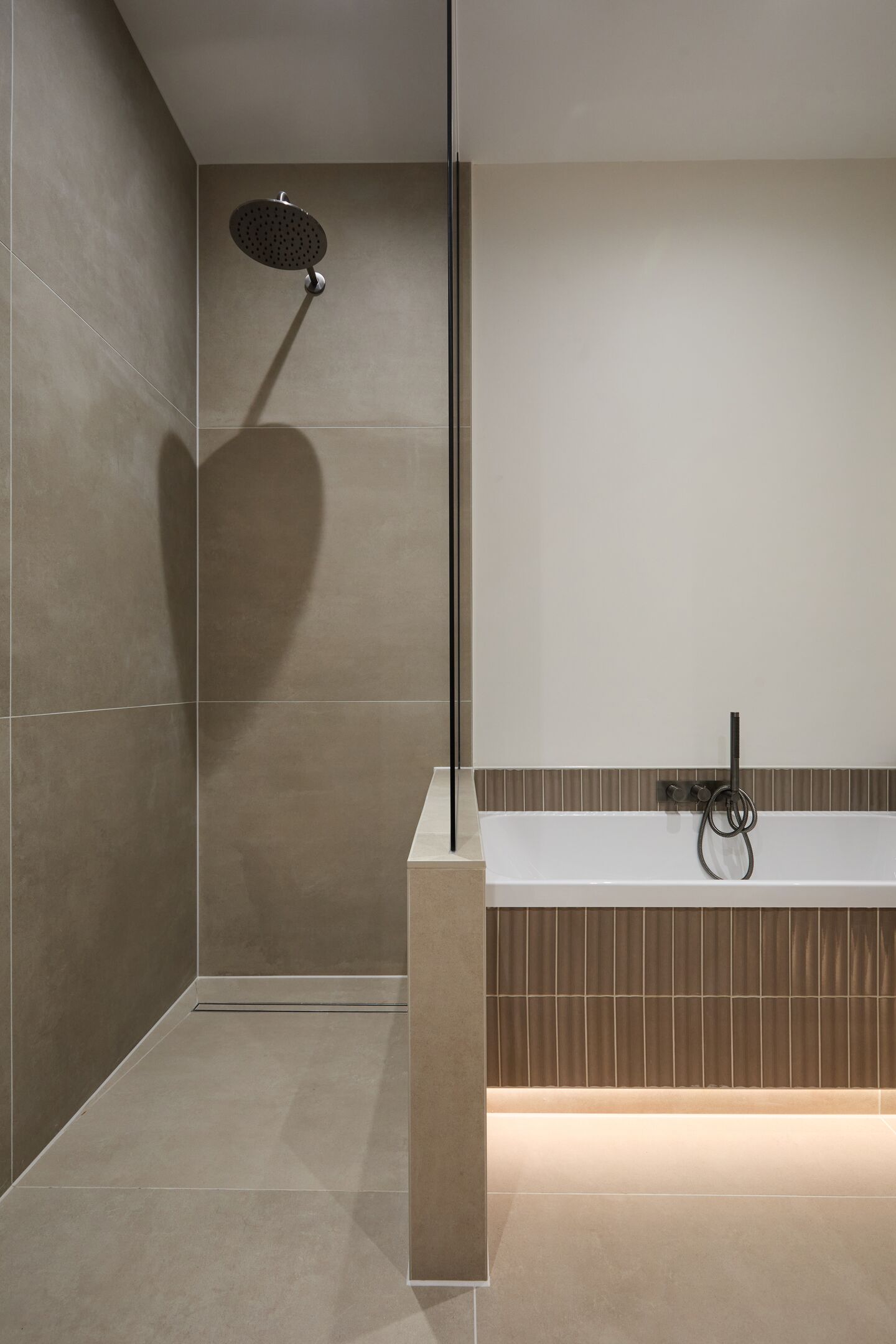Level-access wet-room shower with a slim linear drain flush into the floor beside the bath, Chelmsford CM2 family bathroom