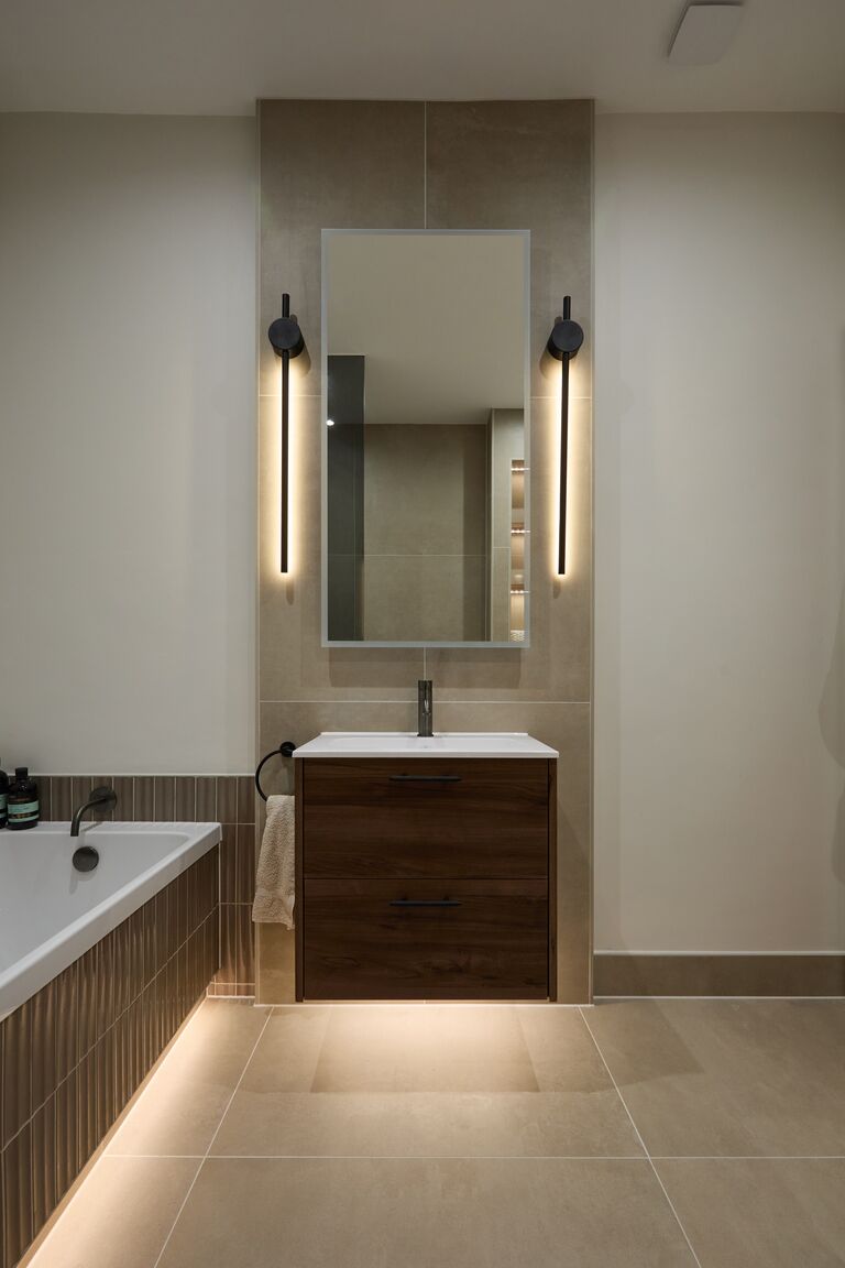 Walnut Calypso vanity with LED underlighting beside bath Chelmsford CM2 Essex
