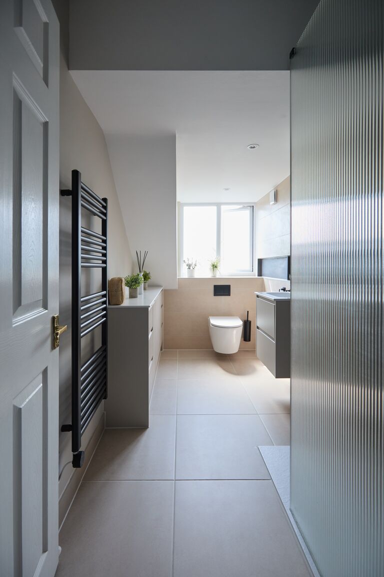 Fluted glass shower screen entry view with black towel rail Chelmsford CM2 Essex Bowman Bathrooms