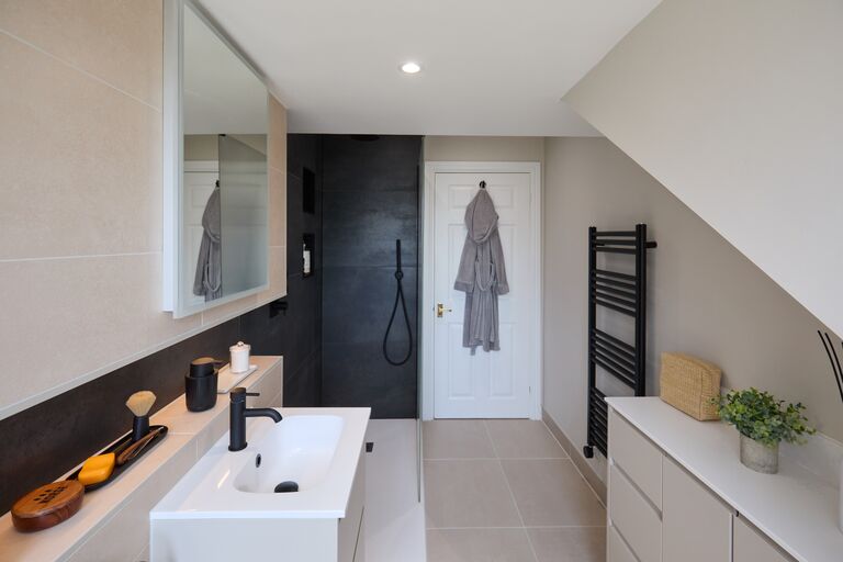 Shower room vanity with dark slate-look feature wall and black towel rail Chelmsford CM2 Essex
