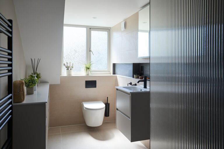 Wall-hung WC and floating vanity beside fluted glass screen Chelmsford CM2 Essex