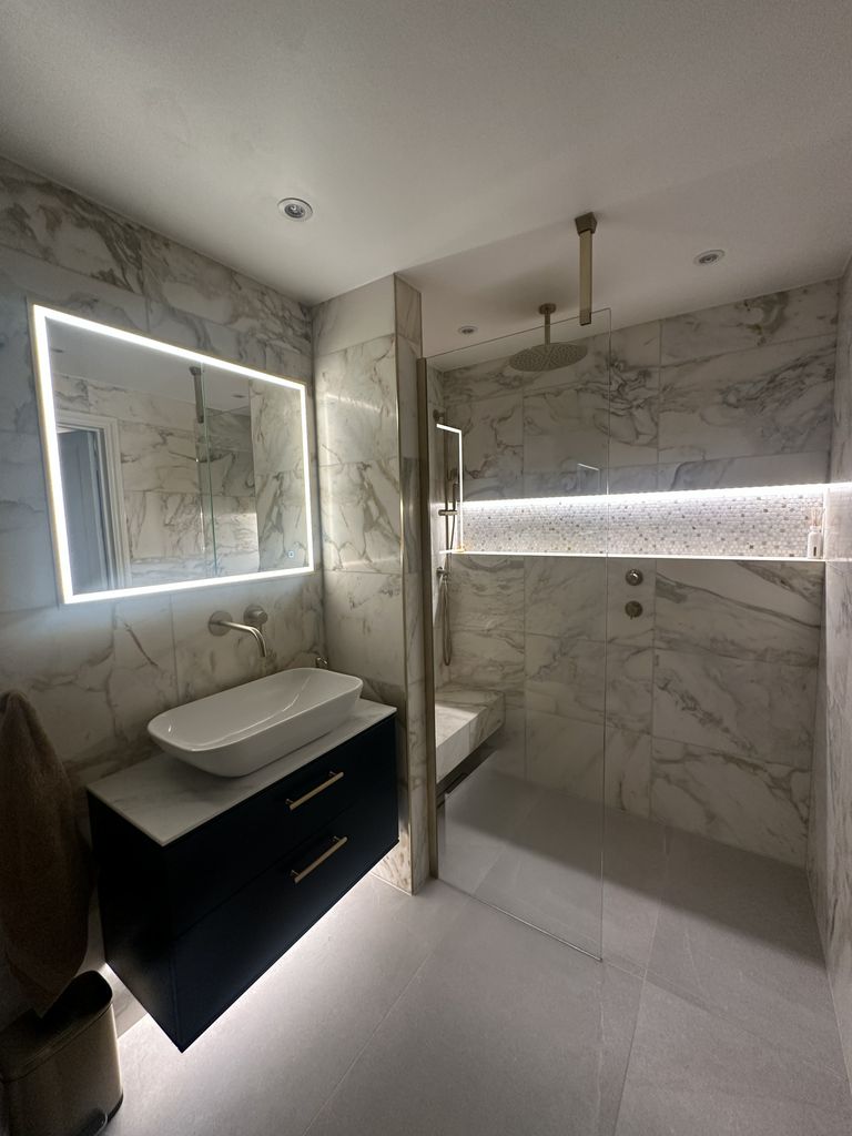 Completed Chelmsford luxury master ensuite with marble walls, navy vanity and walk-in shower matching the 3D design