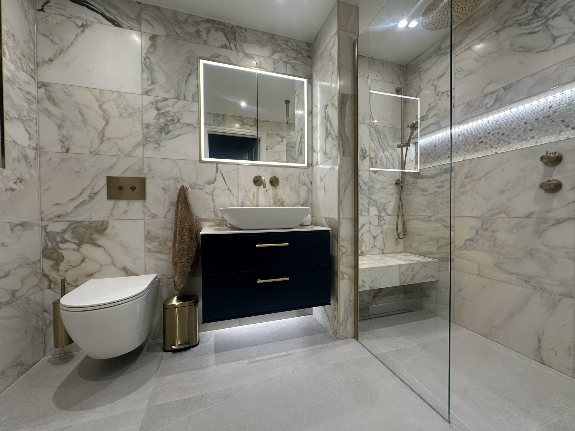 Honed marble master ensuite in Chelmsford CM3 with a brushed brass ceiling rainfall shower