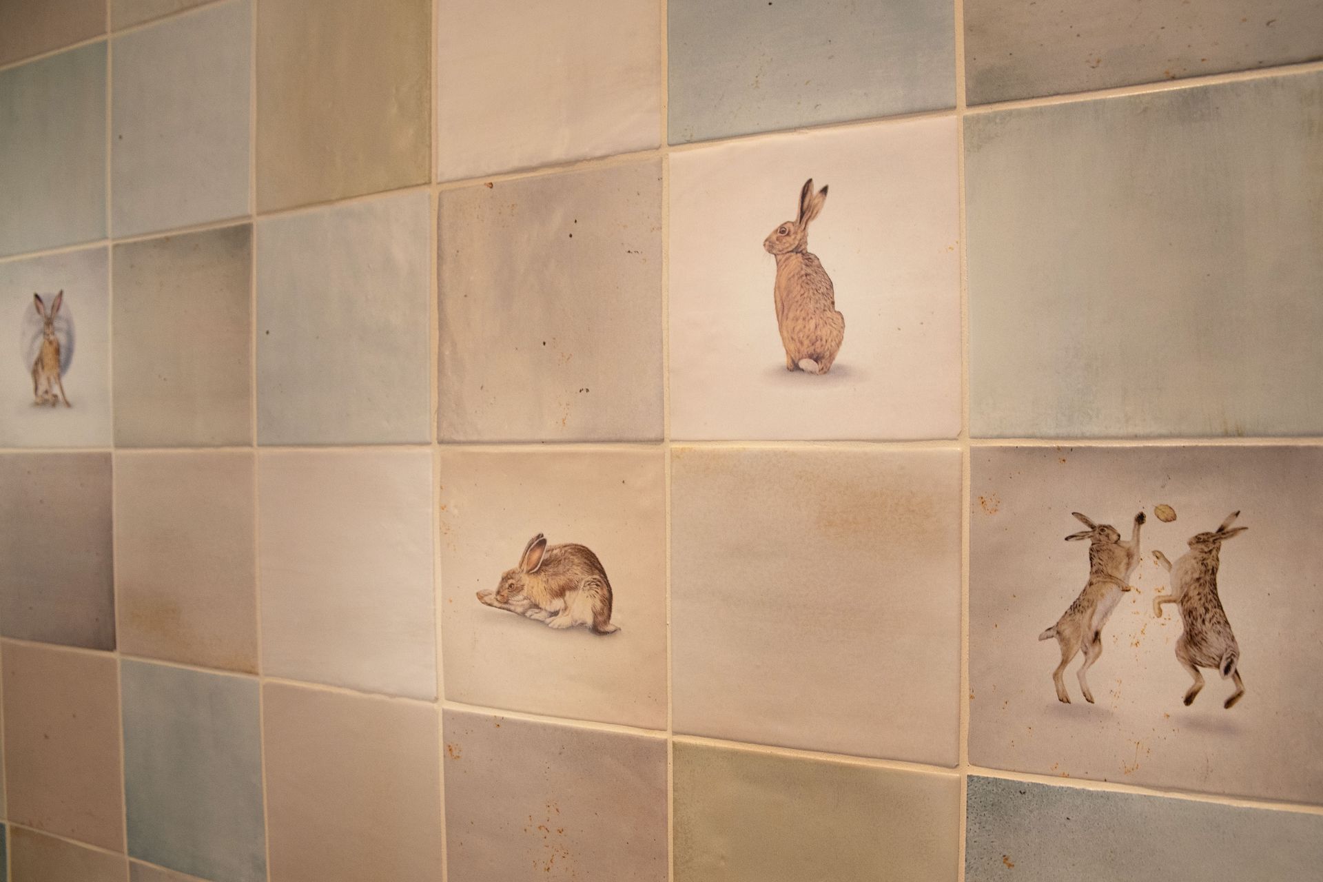 Ca Pietra Wiltshire Hares decorative tiles close-up in Coggeshall CO6 bathroom by Bowmans