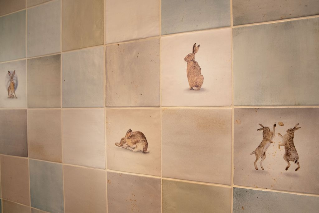 Ca' Pietra Wiltshire Hares hand-painted tiles close-up with sitting sleeping and boxing hares Coggeshall CO6