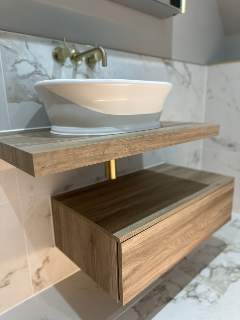 HiB Blend wall-hung vanity with vessel basin and brushed brass wall taps in a Colchester CO1 family bathroom