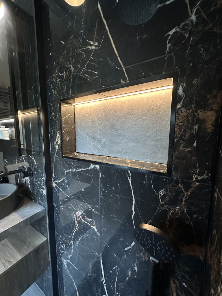 Backlit niche lined in Ca' Pietra Marble Luxe Laurant porcelain with copper veining Gosfield CO9 Essex
