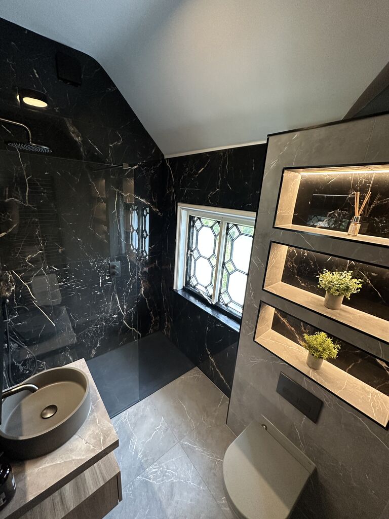 Sloping ceiling shower room in black marble-effect porcelain with three backlit niches Gosfield CO9 Essex