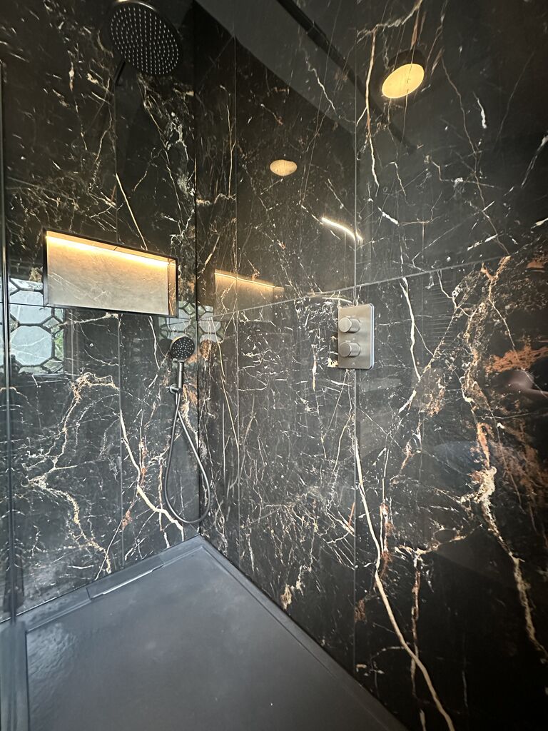 Walk-in wetroom shower with rain head against black marble-effect porcelain Gosfield CO9 Essex