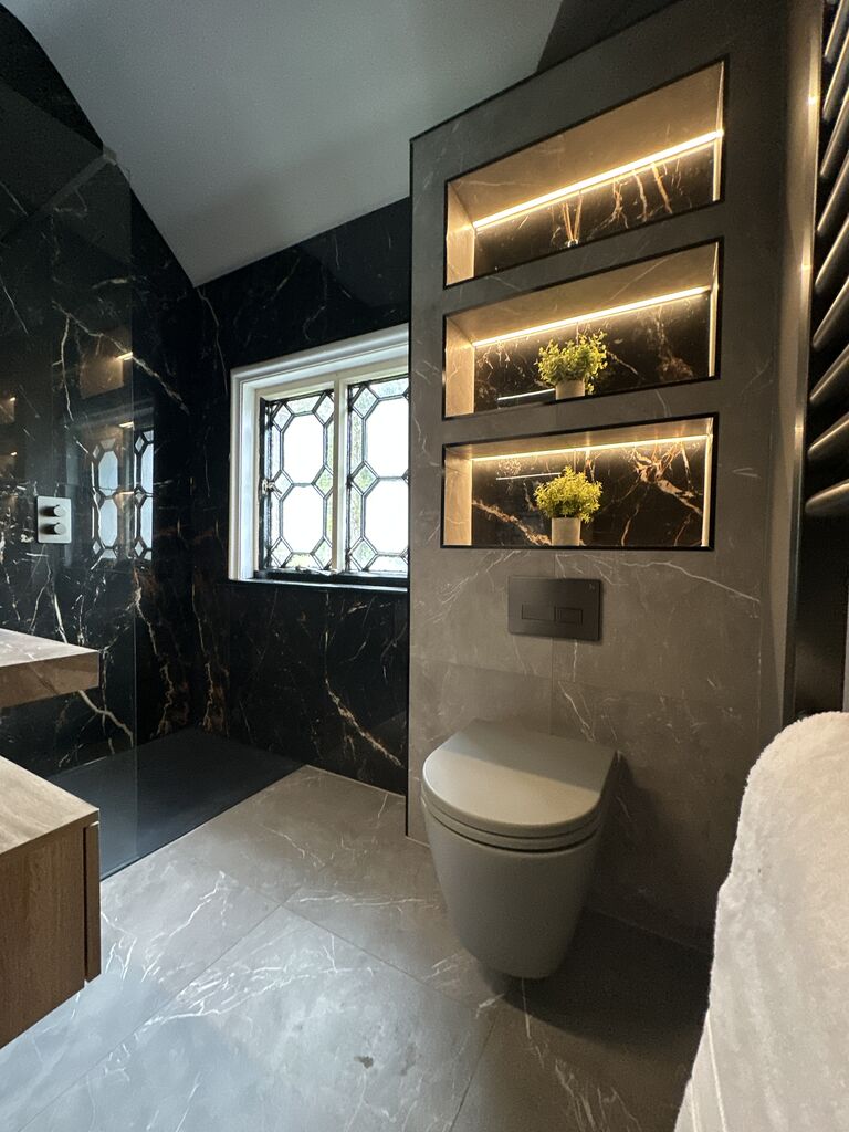 Wall-hung WC beside three backlit niches and a leaded cottage window Gosfield CO9 Essex