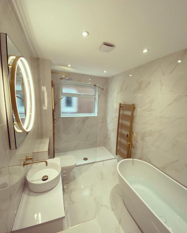 Great Baddow CM2 family bathroom with freestanding bath, Crosswater brushed brass filler, brass towel radiator and HiB Solas round mirror