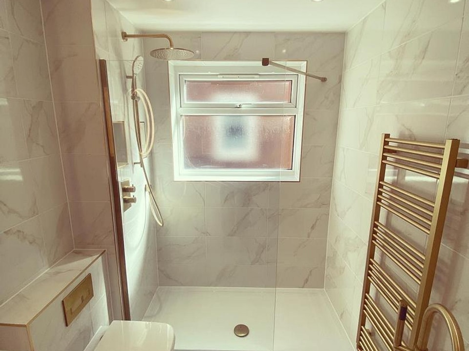 Walk-in shower zone with brass radiator and rimless WC Great Baddow CM2