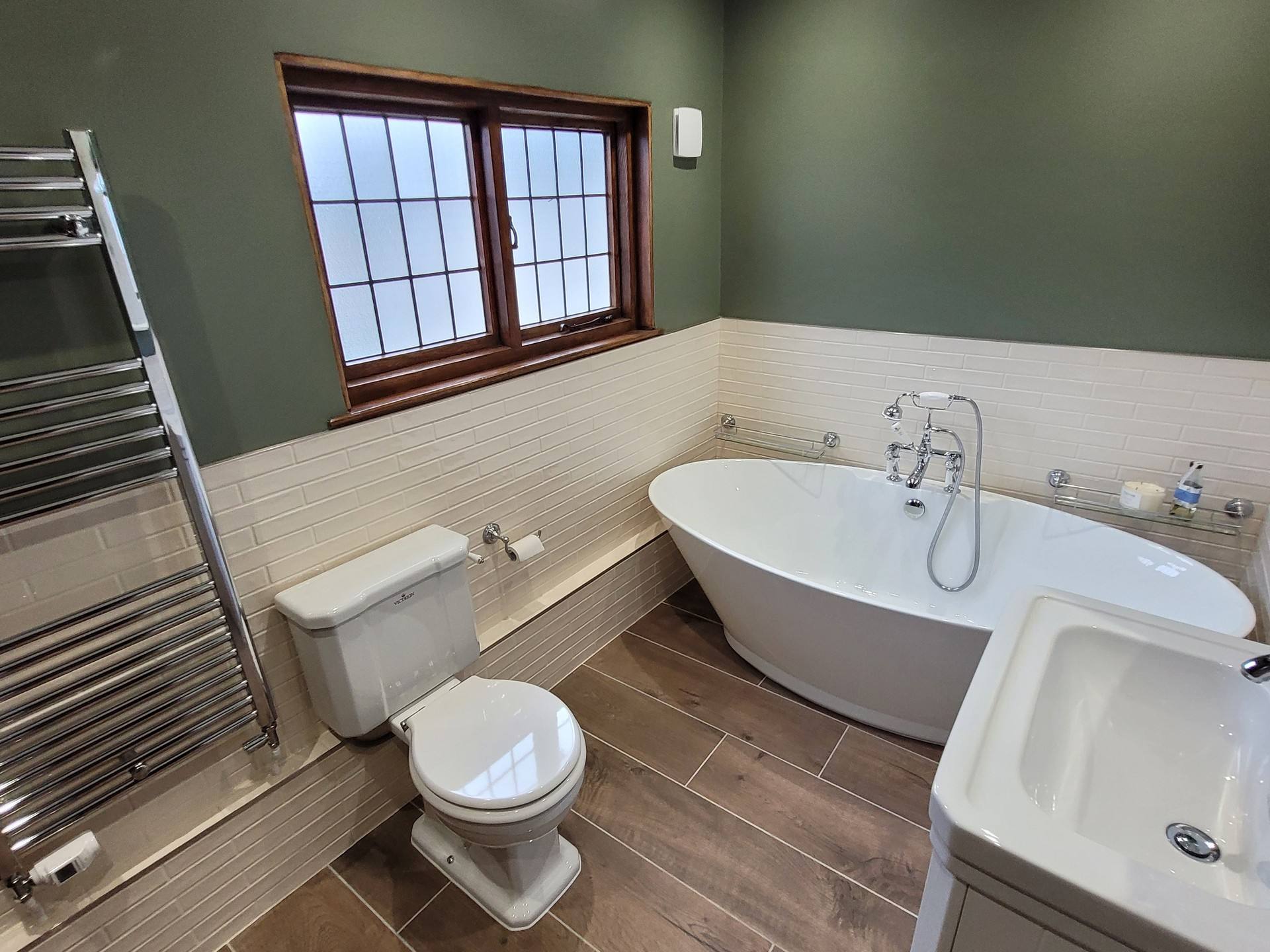 Complete family wetroom from entrance Great Bardfield CM6 freestanding bath WC chrome radiator green walls