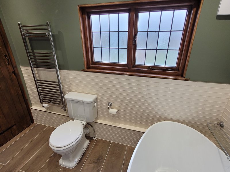 Window wall view with towel radiator WC and freestanding bath Great Bardfield CM6