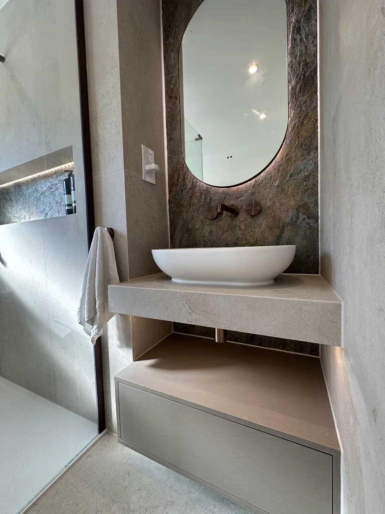 Backlit HiB mirror over floating stone vanity and copper slate feature wall Great Notley CM77 Essex