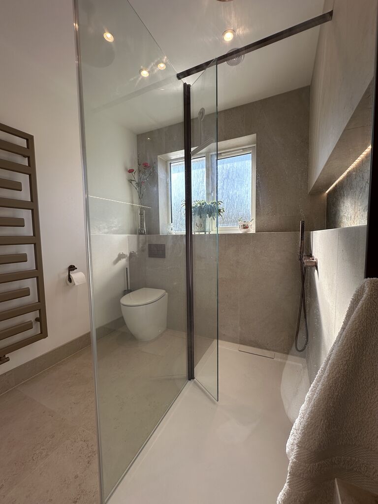 Full room view through the glass screen with Zehnder radiator walk-in shower and vanity Great Notley CM77 Essex