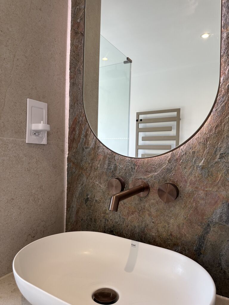RAK Ceramics oval basin with JTP brushed bronze wall-mounted tap on copper slate feature wall Great Notley CM77