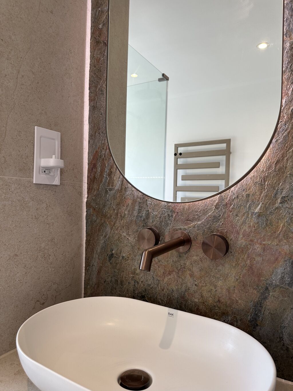 RAK Ceramics oval basin with JTP brushed bronze wall-mounted tap on copper slate feature wall Great Notley CM77