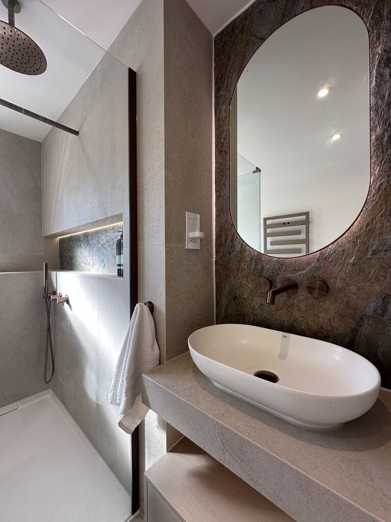 Stone-top vanity with RAK basin HiB mirror and copper slate feature wall Great Notley CM77 Essex
