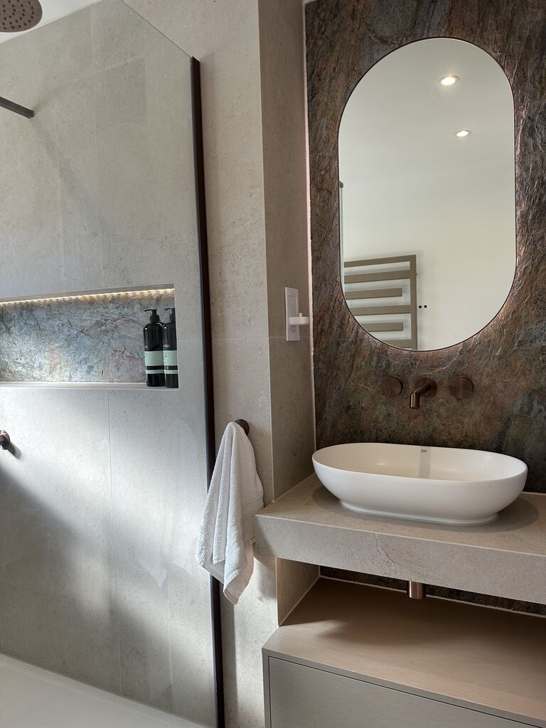 Floating vanity with backlit HiB mirror looking through to the walk-in shower Great Notley CM77 Essex Bowman Bathrooms