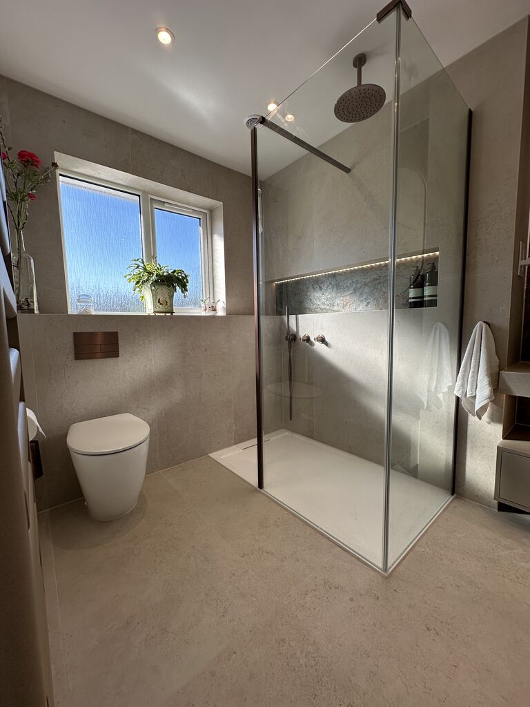 Light-filled walk-in shower with obscured window and wall-hung WC Great Notley CM77 Essex Bowman Bathrooms