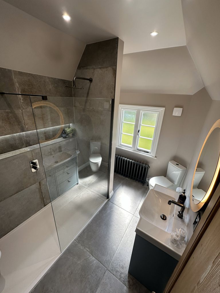 Full room view with Crosswater Gallery 8 walk-in shower, heritage window, cast iron radiator, WC and Coniston Blue vanity Great Saling CM7