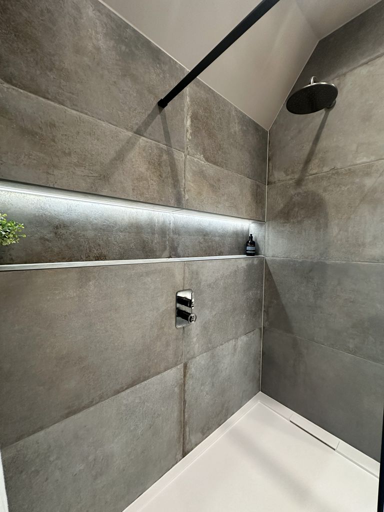 Walk-in shower with LED infinity niche, Ca' Pietra Cenere tiles, and Crosswater Union rain head Great Saling CM7