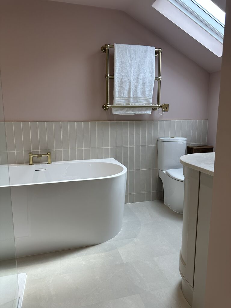 Traditional brass towel warmer above D-shaped bath with WC beyond Great Waltham CM3 Essex