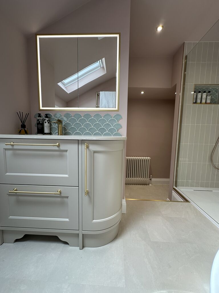 Curved painted vanity with stone top and illuminated mirror in blush pink bathroom Great Waltham CM3 Essex Bowman Bathrooms