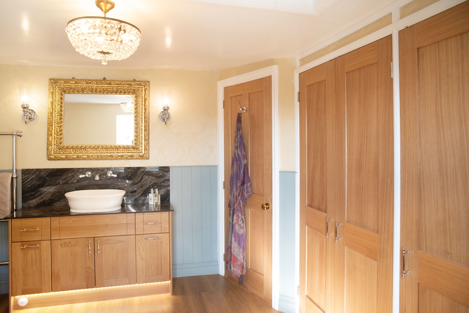 Bespoke oak cupboard doors and bedroom access door with crystal chandelier and Burlington wall lights Halstead CO9