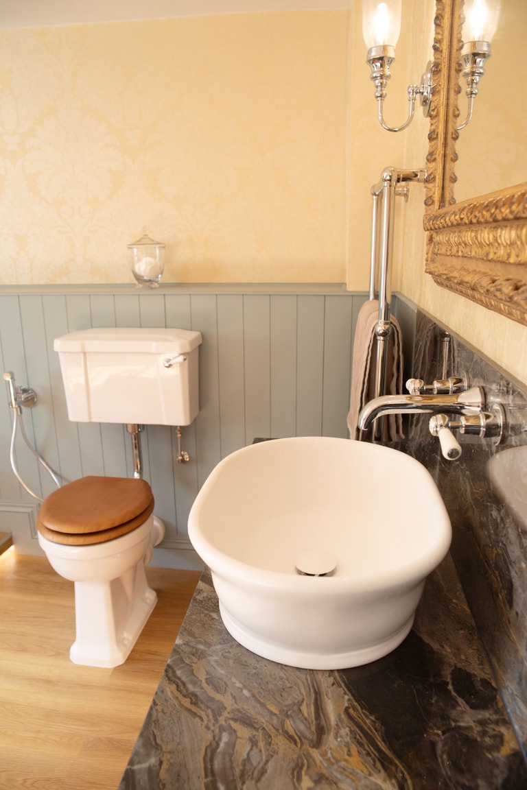 BC Designs WC with wooden seat and vessel basin on granite worktop with chrome taps Halstead CO9