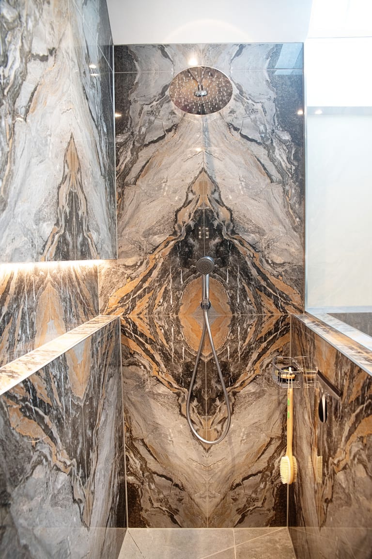 Ca' Pietra Nero Magnifique bookmatched tiles with infinity niche in luxury wetroom Halstead CO9