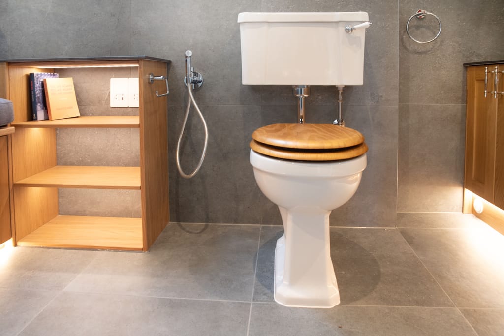 Traditional WC with wooden seat and Calypso oak open shelving with LED floor strip Halstead CO9