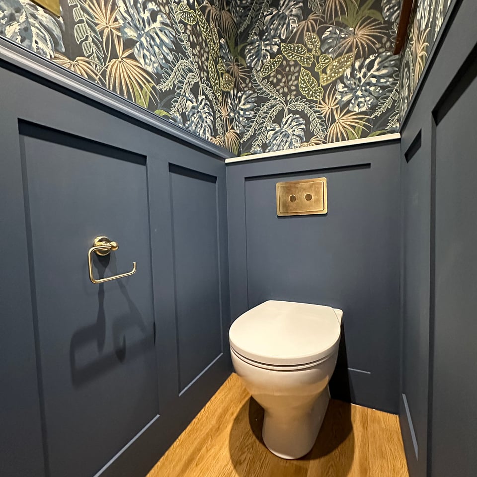 Wall-hung WC with navy panelling jungle wallpaper and JTP Grosvenor brass flush plate Hatfield Peverel CM3 cloakroom