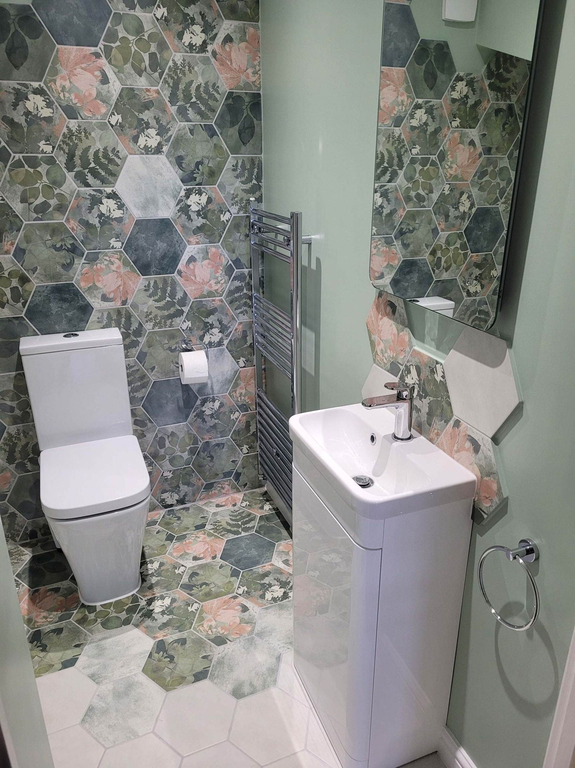 HiB Air LED mirror above Roper Rhodes vanity with Woodland Glade feature wall and chrome towel ring Highwoods Colchester CO4