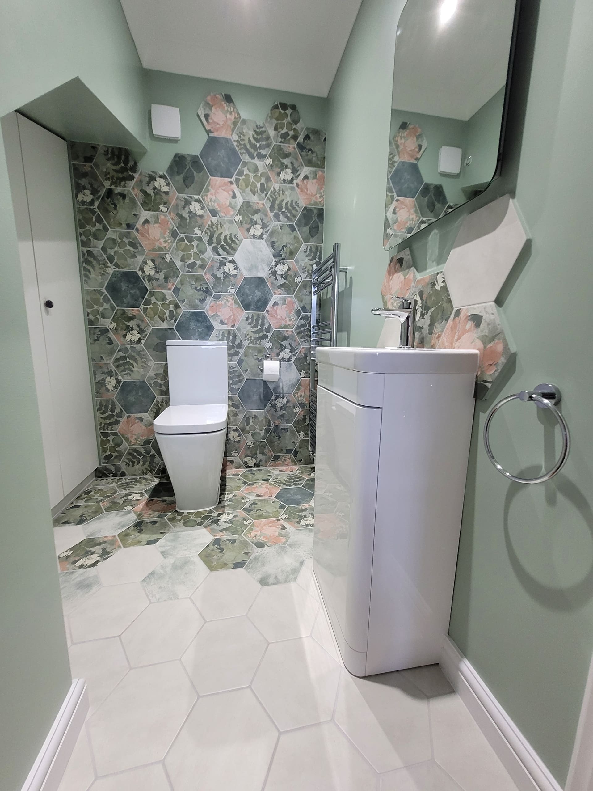 Sage green downstairs toilet with Ca' Pietra hexagon floor tile and curved white vanity, Colchester
