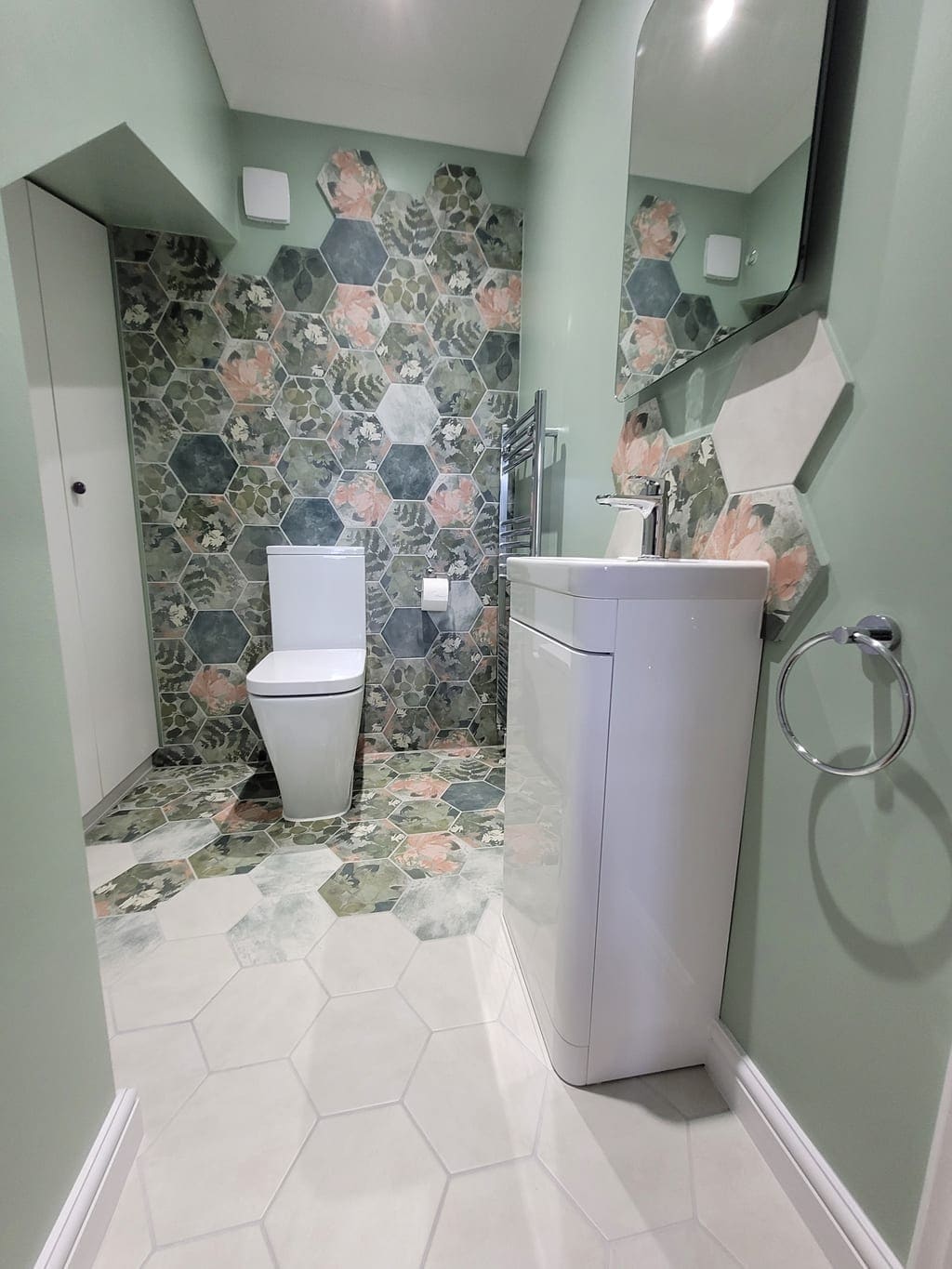 Completed cloakroom with Ca' Pietra Woodland Glade hexagon feature wall, Shadow White floor tiles, and sage green walls Highwoods Colchester CO4