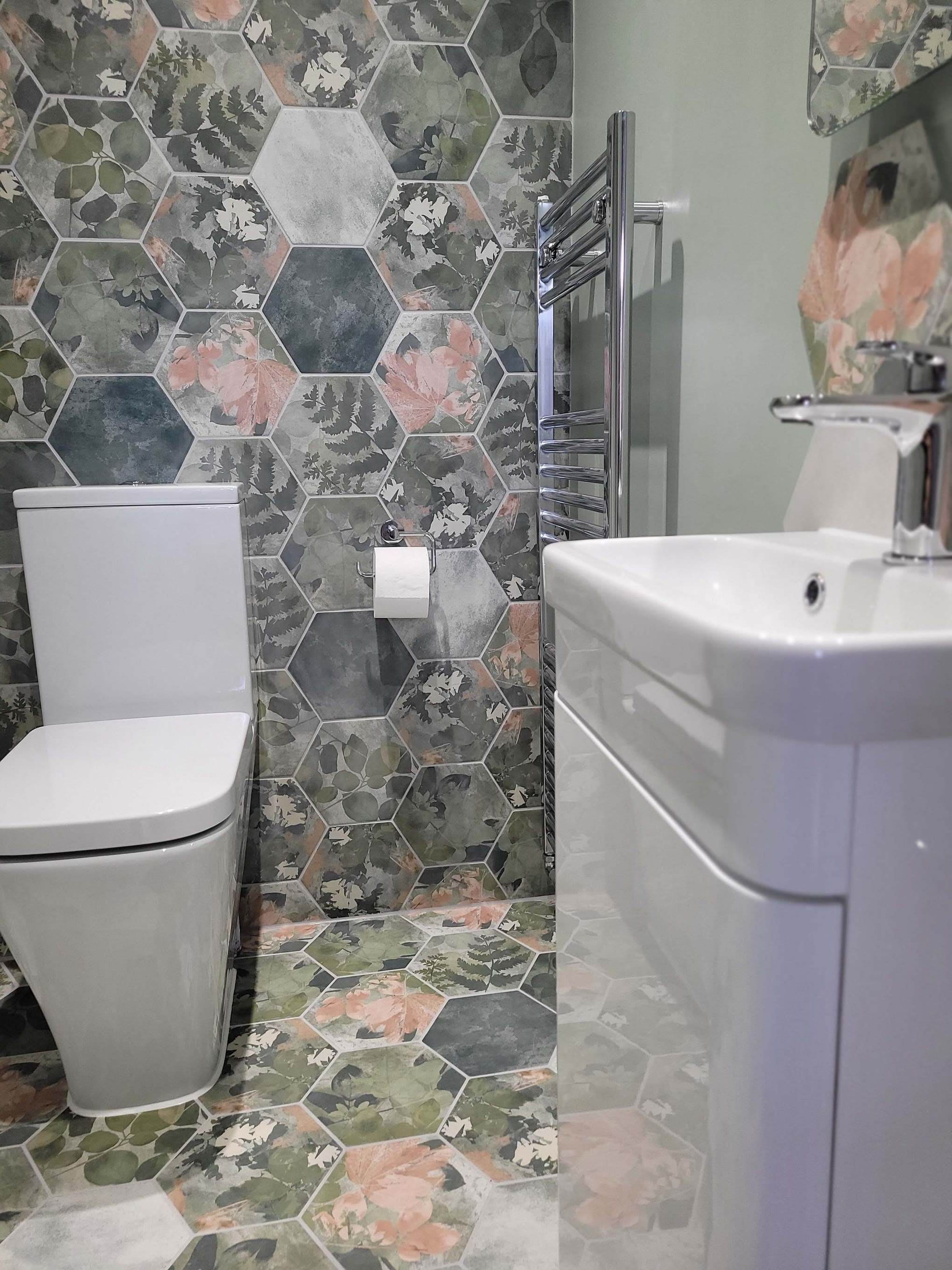 Roper Rhodes System white vanity with basin and chrome heated towel rail beside Woodland Glade tiles Highwoods Colchester CO4