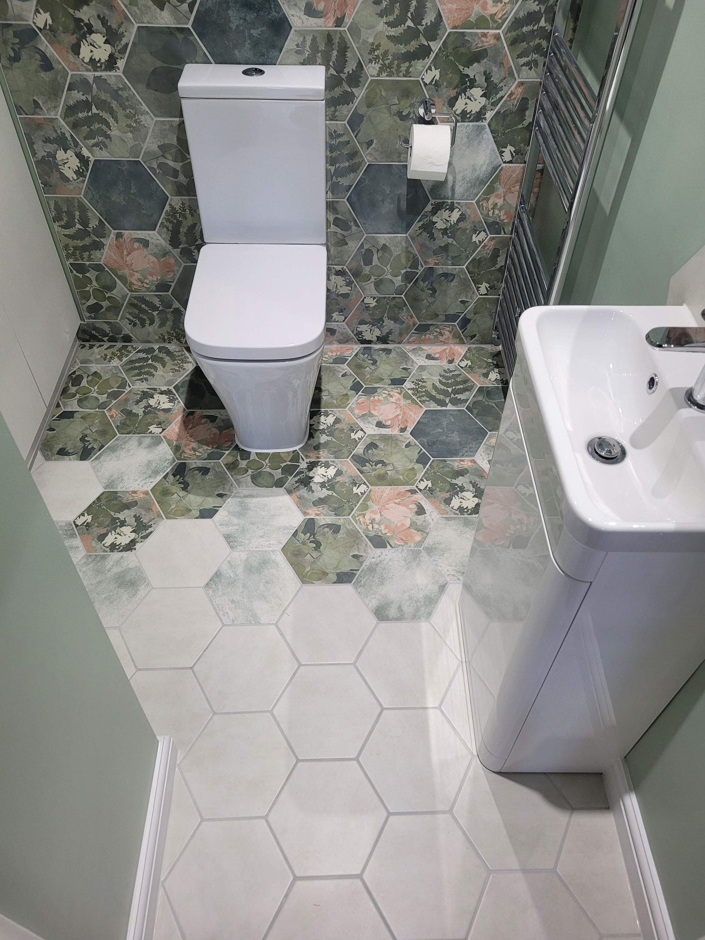 Shadow White hexagon floor tiles blending into Woodland Glade feature wall with WC and Roper Rhodes vanity Highwoods Colchester CO4