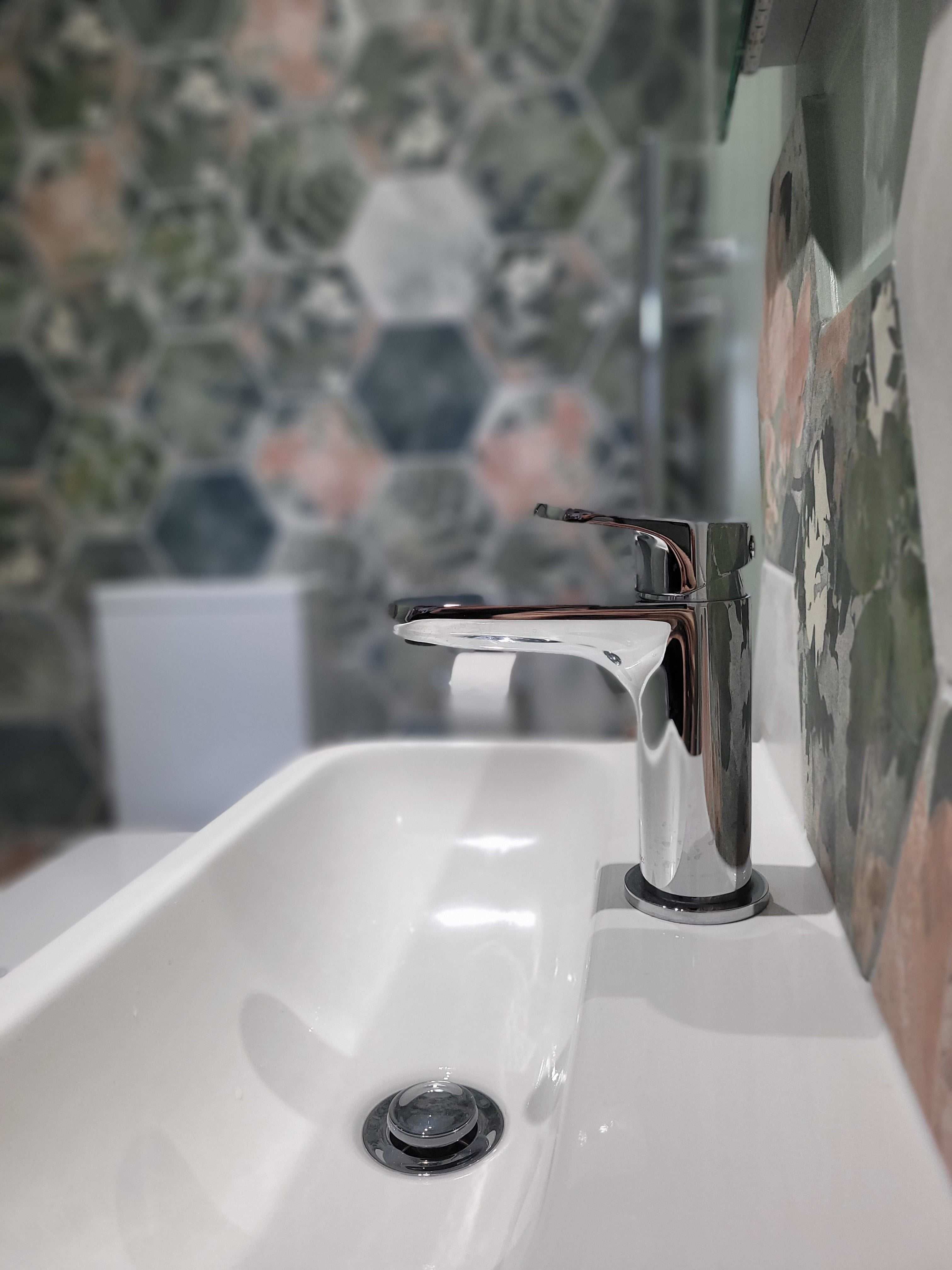 Roper Rhodes Clear Mini chrome basin mixer close-up with Woodland Glade tiles reflected in mirror Highwoods Colchester CO4