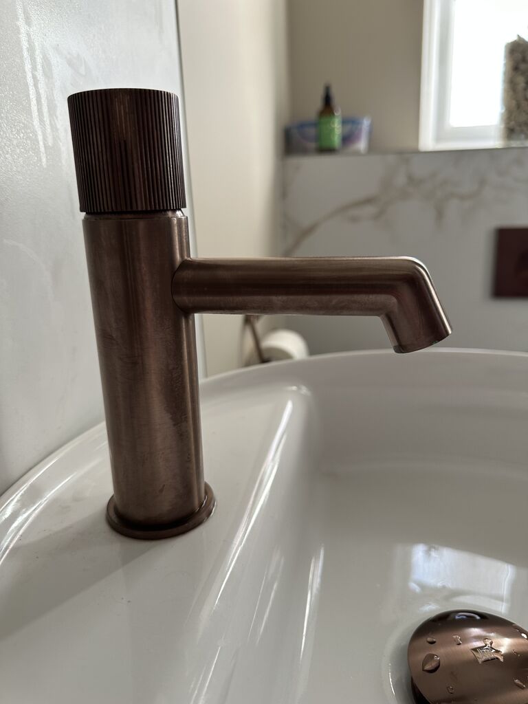 Brushed bronze basin tap detail on round cloakroom basin Kelvedon CO5 Essex