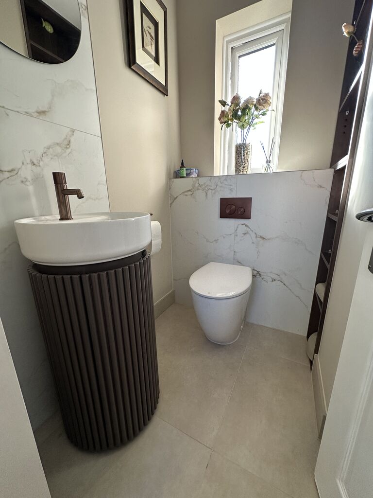 Fluted walnut basin unit with brushed bronze tap in luxury cloakroom Kelvedon CO5 Essex Bowman Bathrooms
