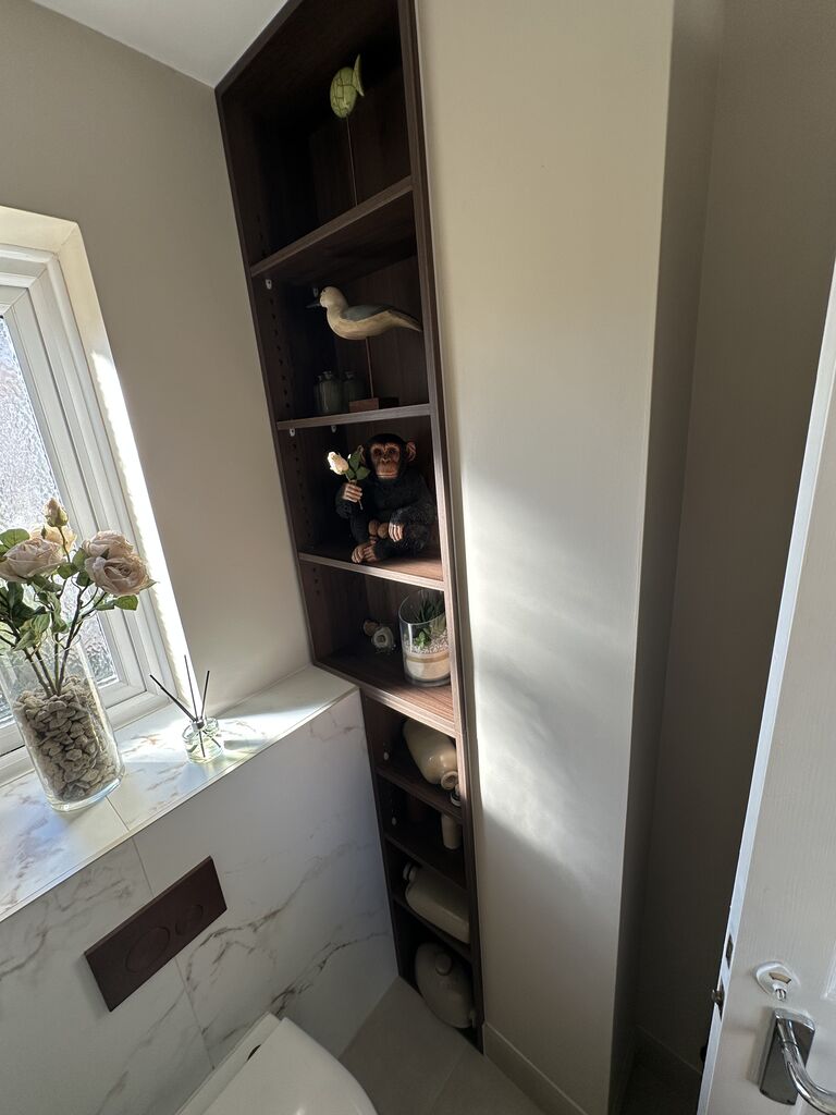 Marble-look sill and walnut shelves by the cloakroom window Kelvedon CO5 Essex