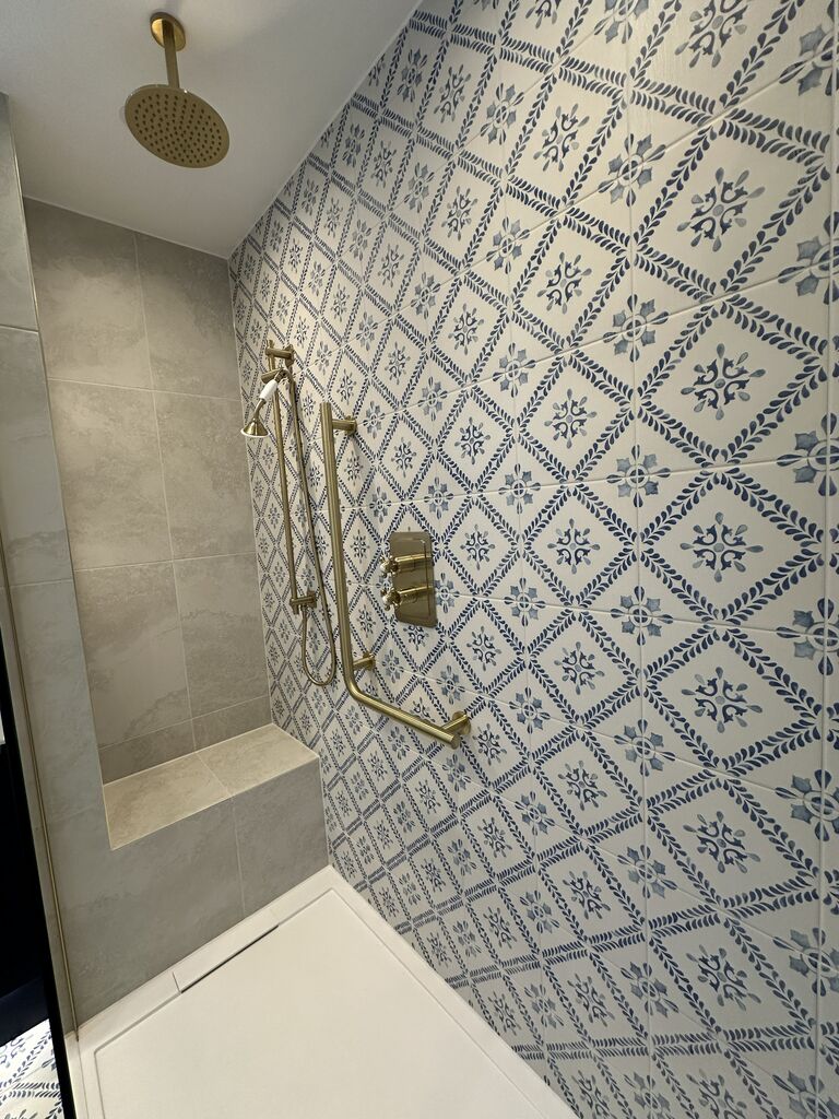 Walk-in shower with blue and white patterned tile feature wall and tiled bench Kelvedon CO5 Essex
