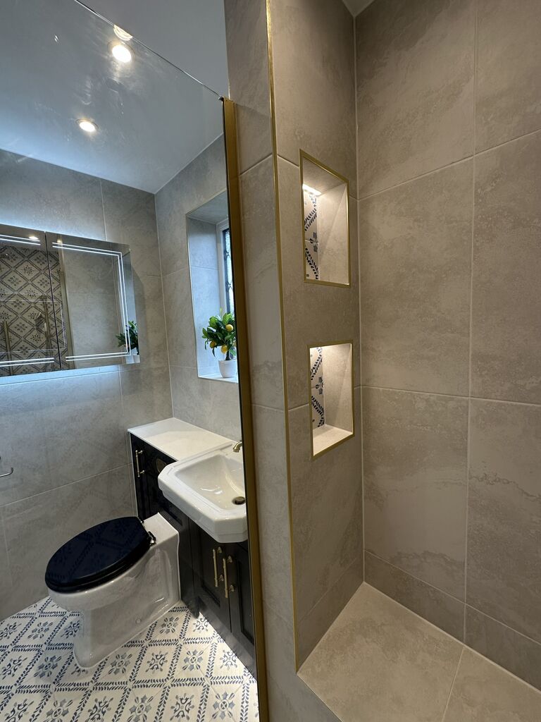 Two lit recessed niches lined in patterned tile with brushed brass edging Kelvedon CO5 Essex shower room